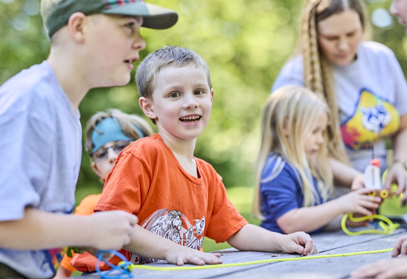 Cub Scouts and parents working through an activity together at a table